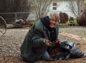 Bernice picking up pine cones in yard.jpg